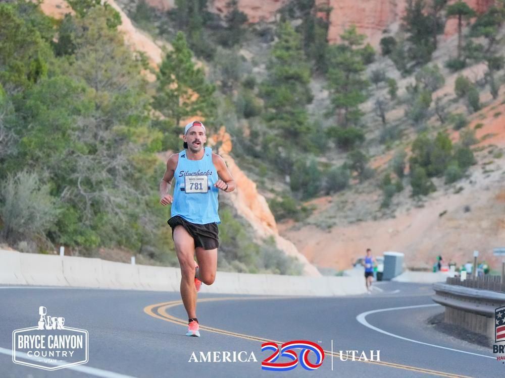 Alex T. Baker running a canyon road at Bryce.